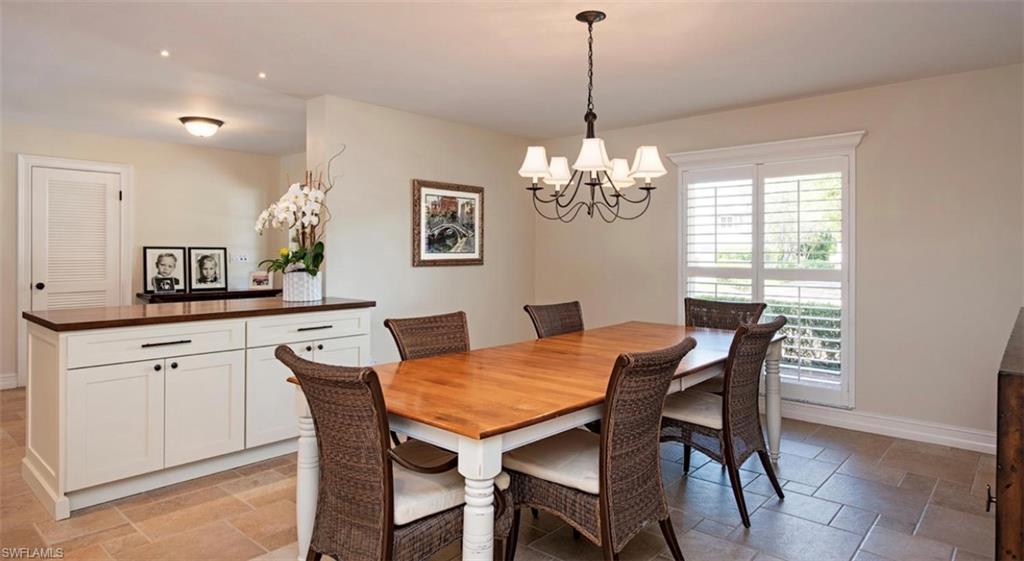 508 Devils Lane Naples, FL 34103 - Photo 5 of 15 a view of a dining room with furniture a chandelier and wooden floor