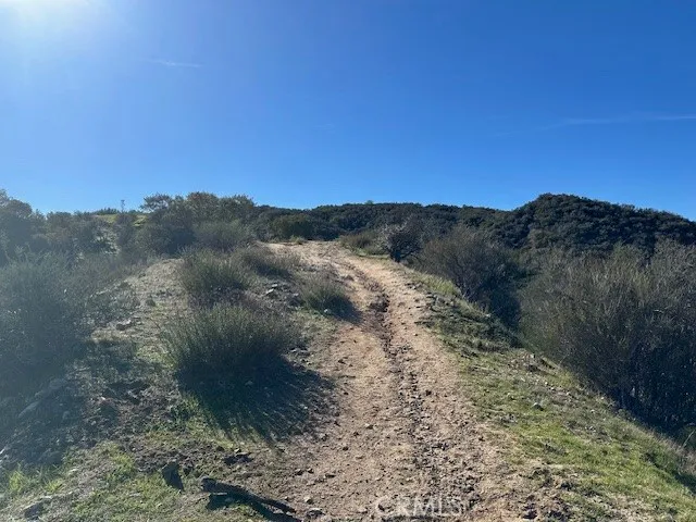 a view of mountain with sunset in background