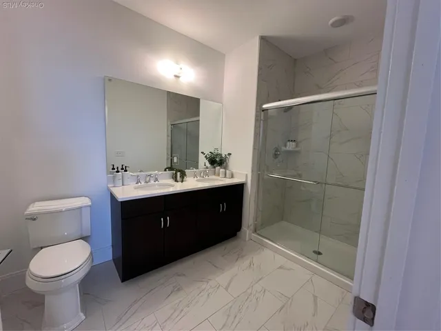 a bathroom with a sink toilet and shower