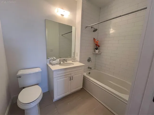a bathroom with a granite countertop toilet a sink and bathtub