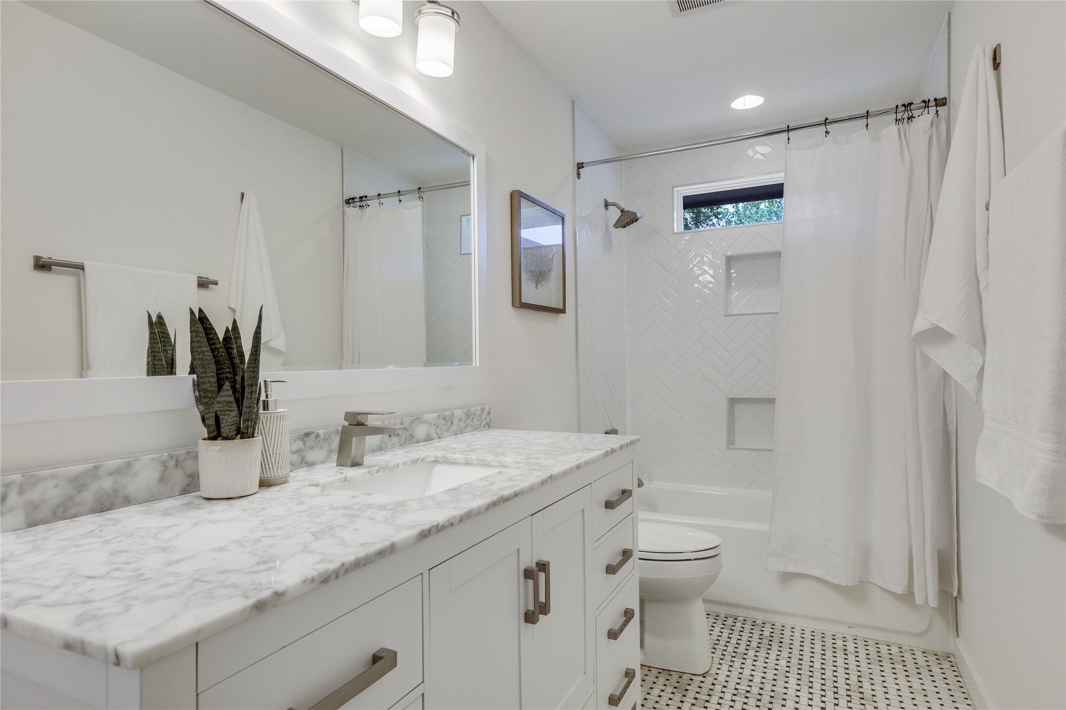 5203 Ledesma Road Austin, TX 78721 - Photo 18 of 40 Marble vanity and tiled shower enhance this well-appointed bathroom.