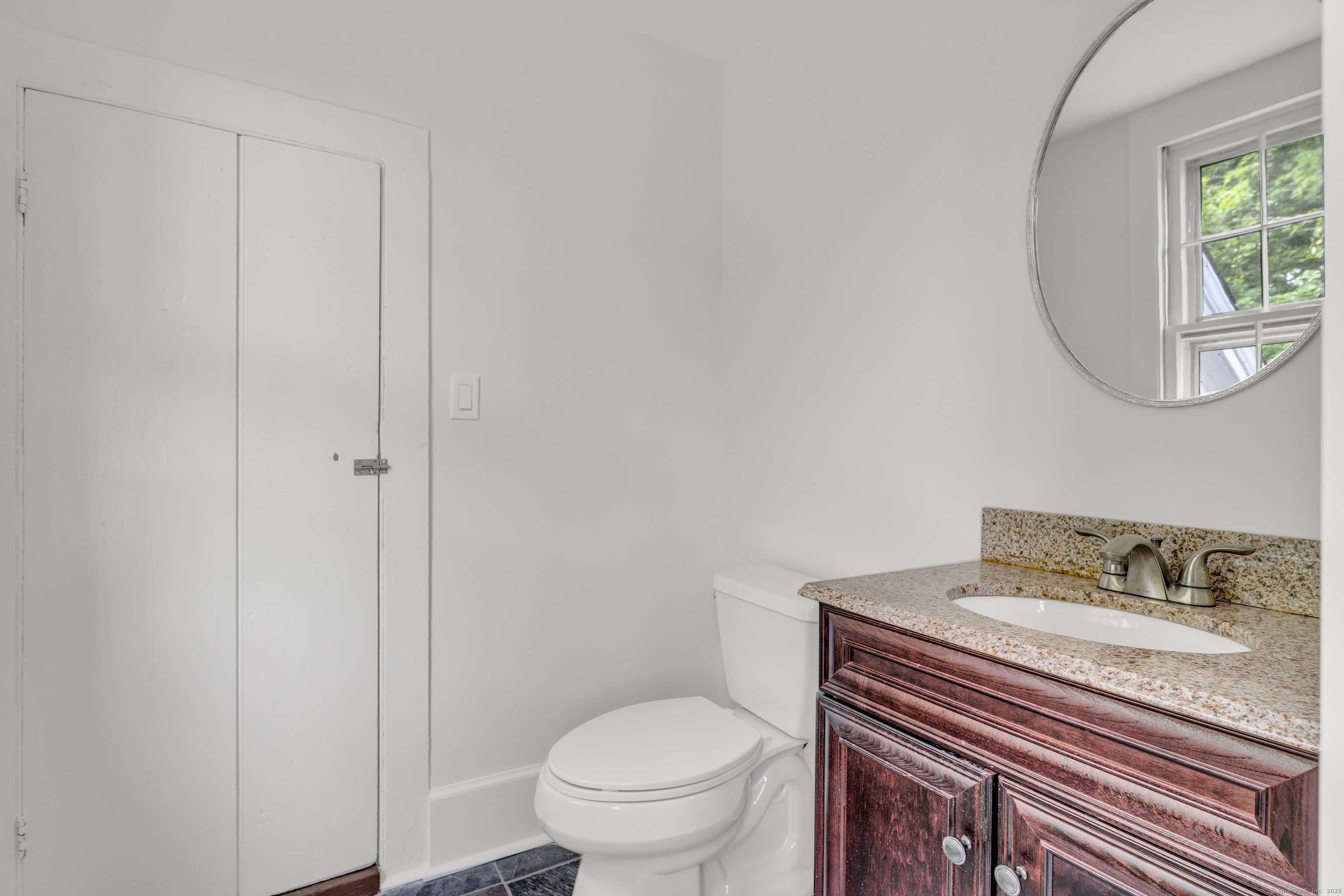 108 Boston Post Road Madison, CT 06443 - Photo 13 of 27 a bathroom with a granite countertop toilet and a sink