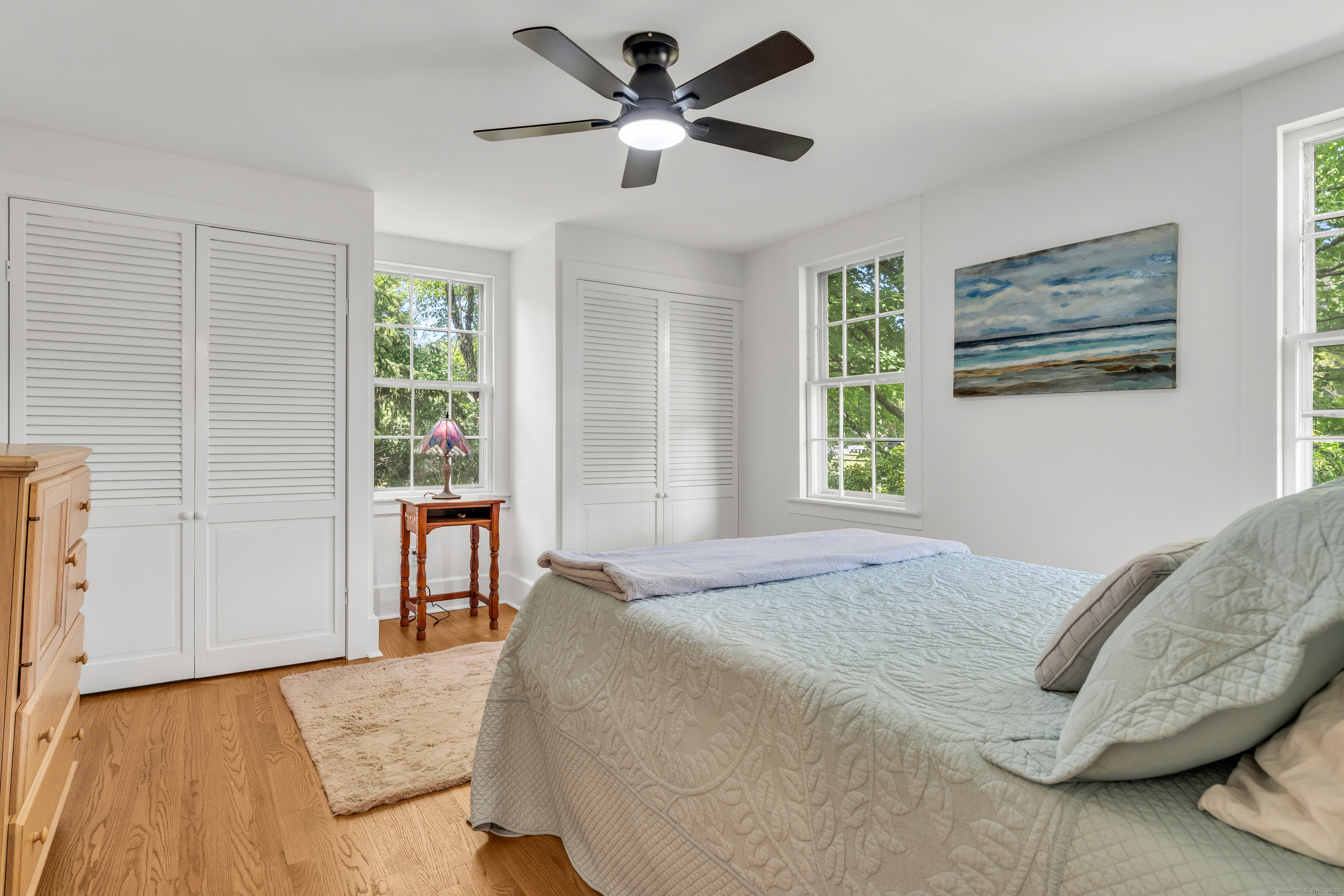 108 Boston Post Road Madison, CT 06443 - Photo 15 of 27 a bedroom with a bed and a large window