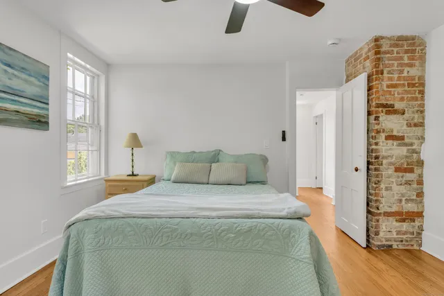 a bedroom with a large bed and a large window
