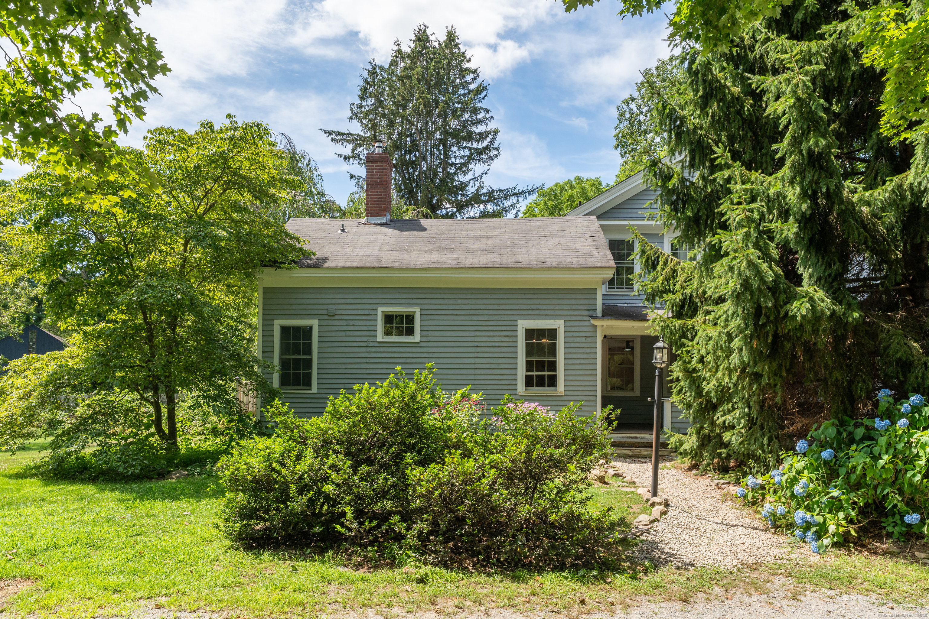 108 Boston Post Road Madison, CT 06443 - Photo 22 of 27 a front view of a house with garden