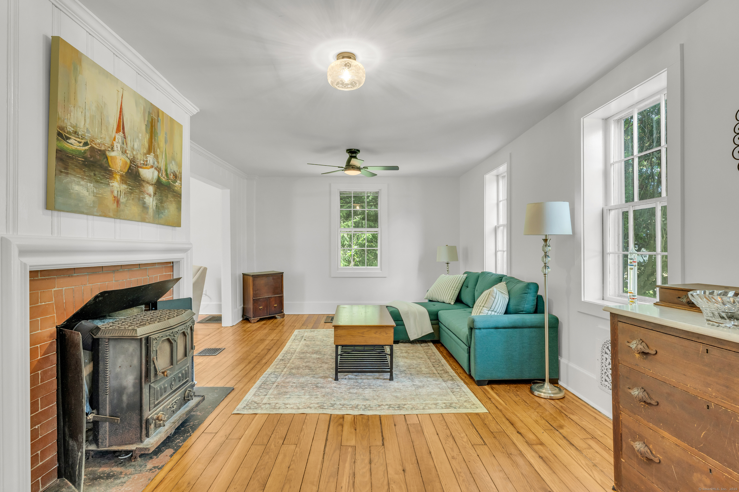 108 Boston Post Road Madison, CT 06443 - Photo 3 of 27 a living room with furniture and a fireplace