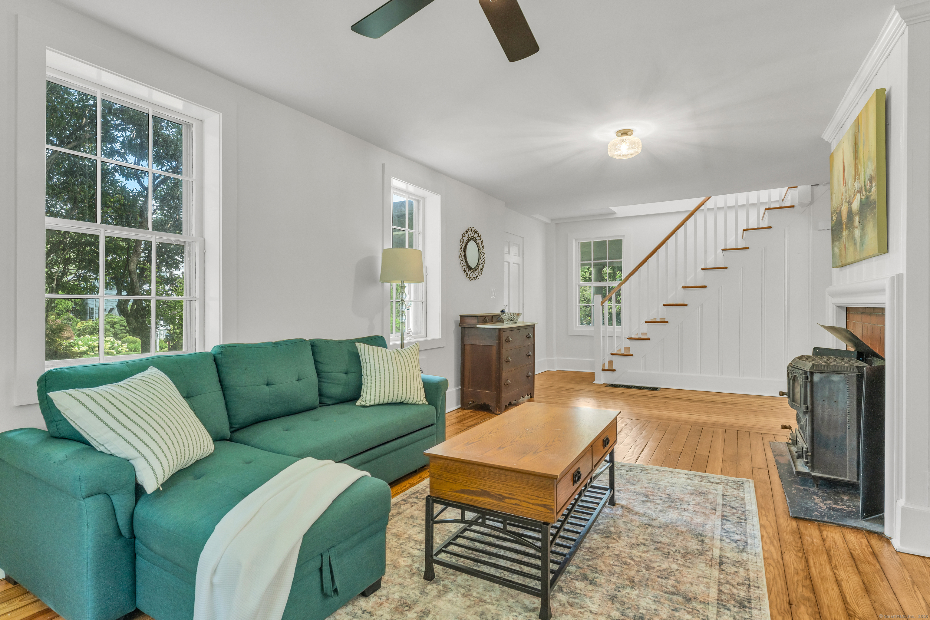 108 Boston Post Road Madison, CT 06443 - Photo 4 of 27 a living room with furniture and a fireplace