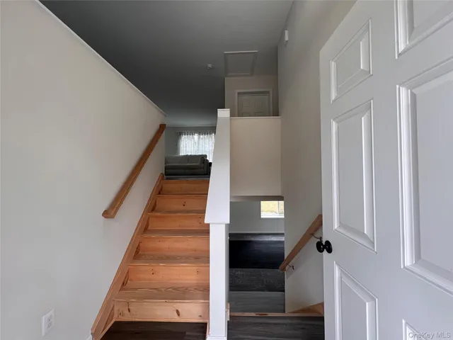 a view of entryway and hall with wooden floor