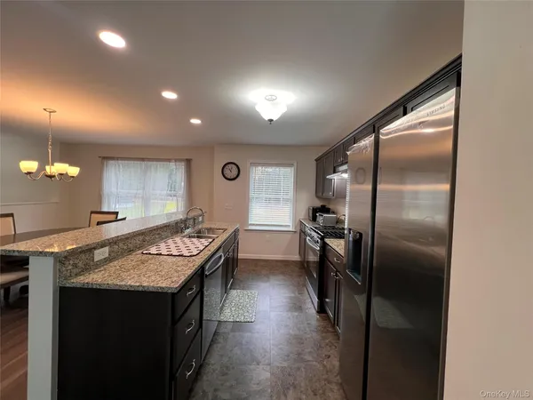 a kitchen with refrigerator and window