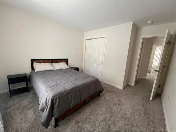 a bedroom with a bed and a mirror