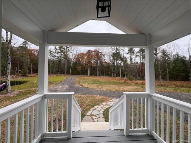 a view of a porch with a floor to ceiling window