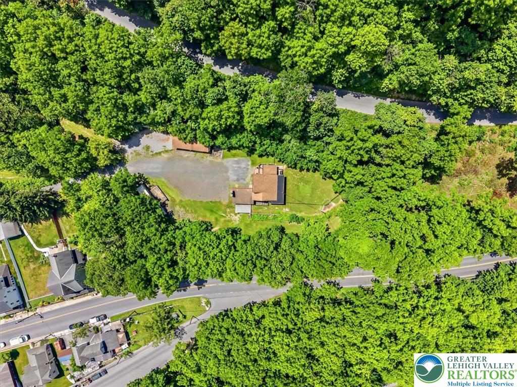 5340 2nd Street Whitehall, PA 18052 - Photo 28 of 30 An aerial perspective showcases a secluded home enveloped by a vibrant, mature tree canopy, offering privacy.