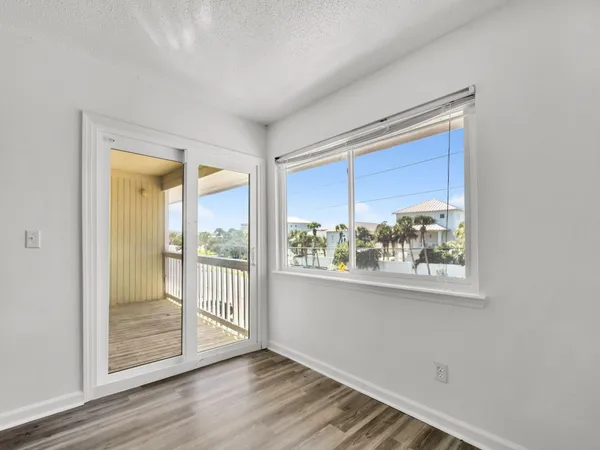 an empty room with wooden floor and a window