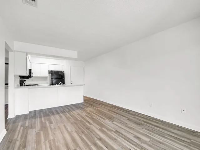 a view of kitchen with sink and wooden floor