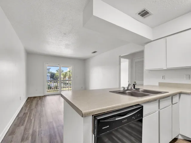 a kitchen that has a sink and a stove in it