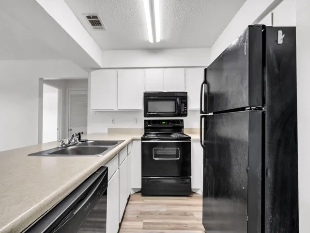 a kitchen with a refrigerator and a sink