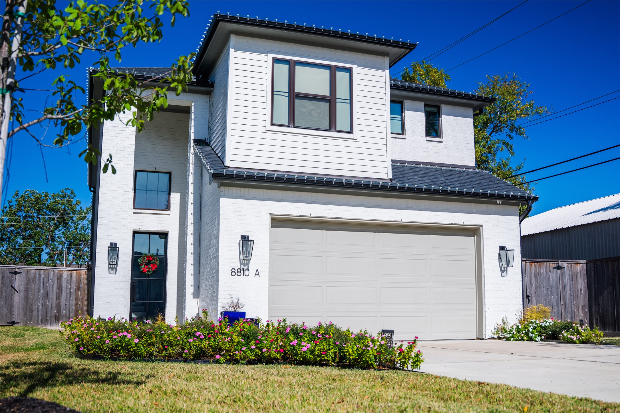 8810 Carousel Lane Houston, TX 77080 - Photo 1 of 37 a front view of a house with a yard and garage