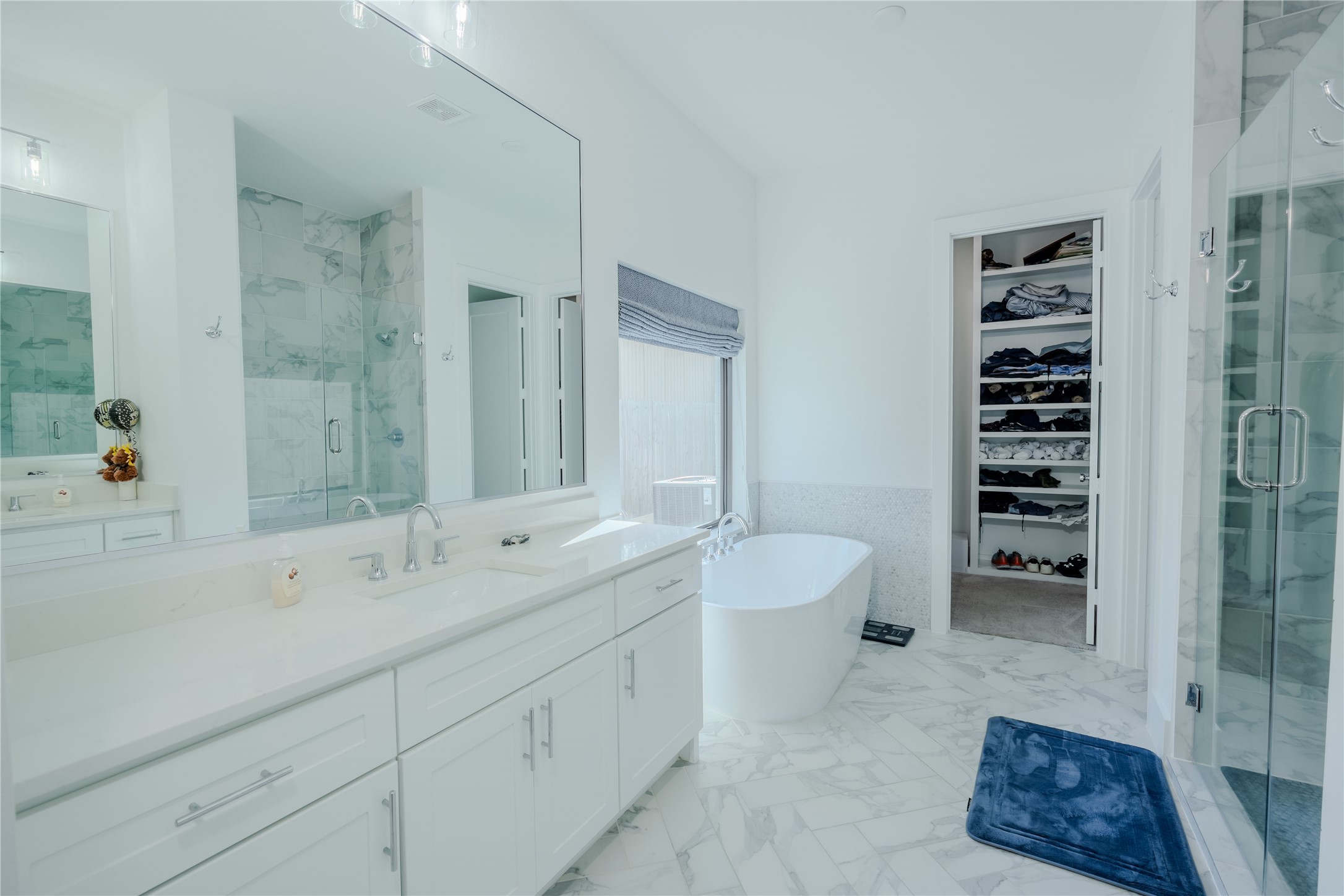 8810 Carousel Lane Houston, TX 77080 - Photo 15 of 37 a spacious en suite bathroom with a double vanity sink a toilet a mirror and shower