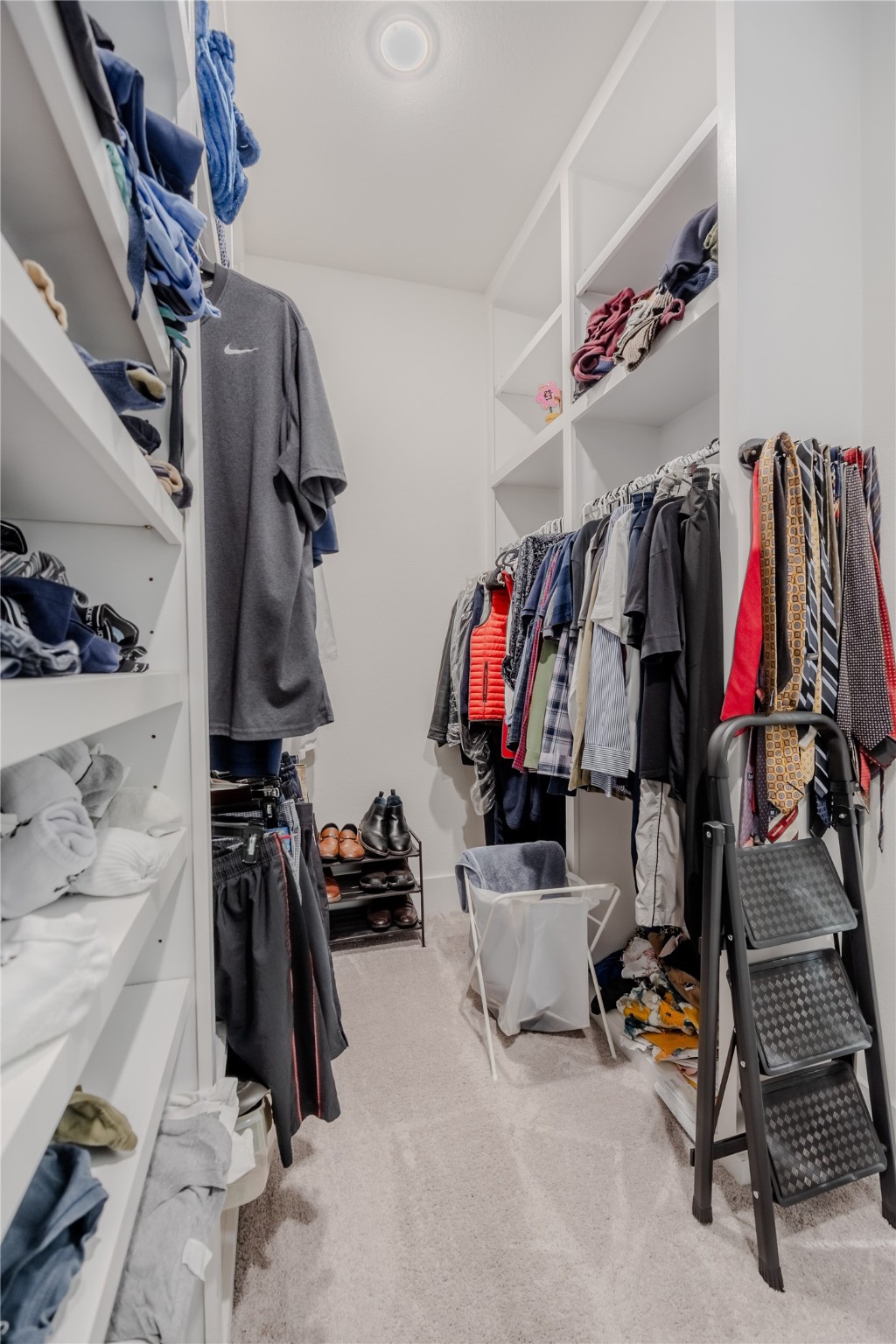 8810 Carousel Lane Houston, TX 77080 - Photo 20 of 37 a view of walk in closet with clothes and shoes