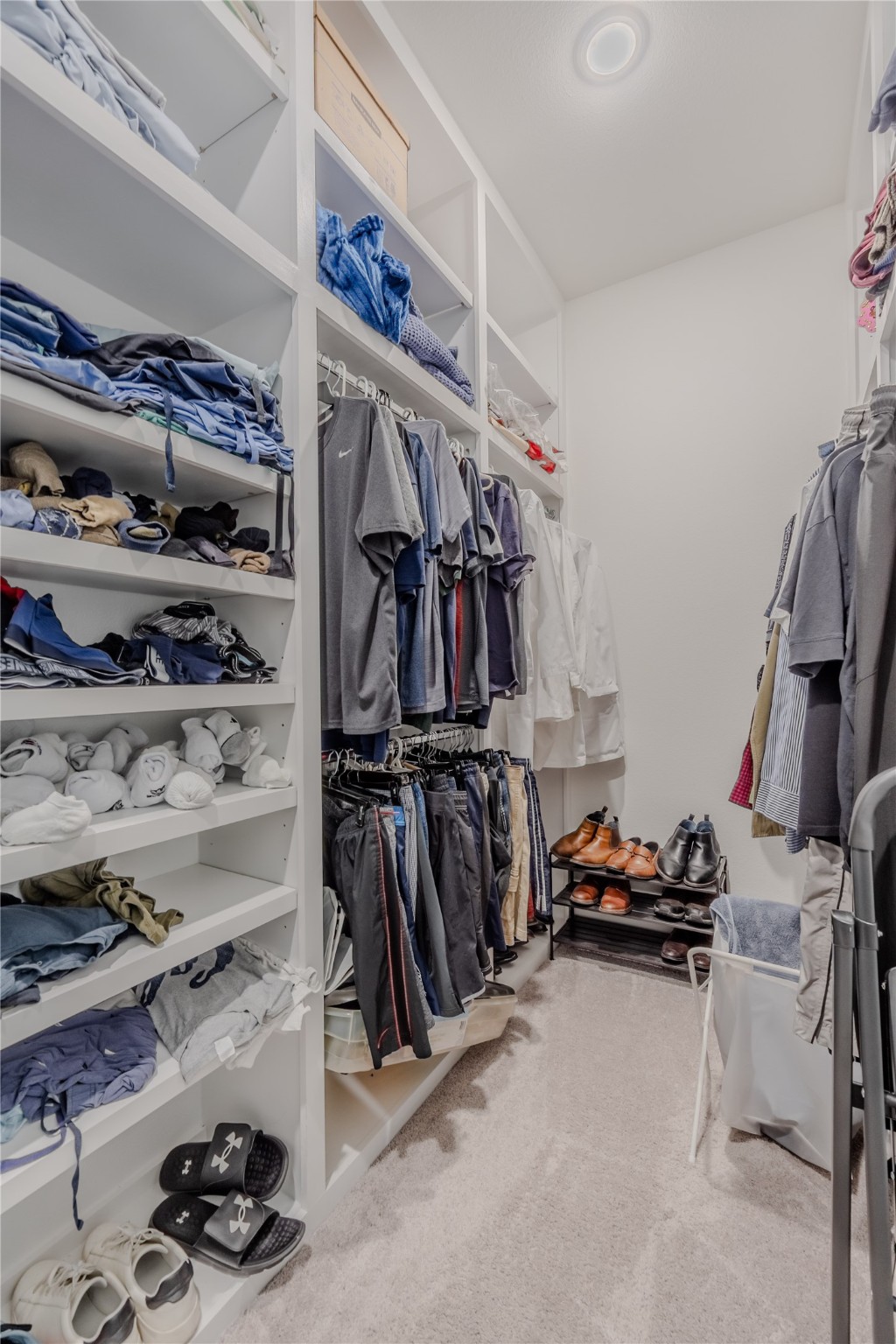 8810 Carousel Lane Houston, TX 77080 - Photo 21 of 37 a view of walk in closet with clothes and shoes