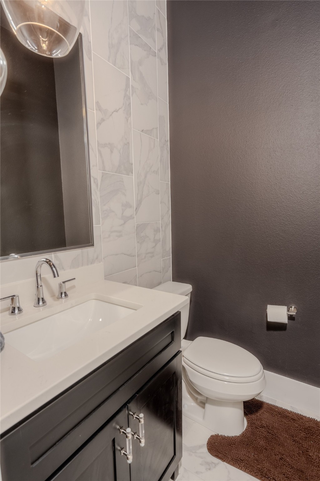 8810 Carousel Lane Houston, TX 77080 - Photo 23 of 37 a bathroom with a sink a toilet a mirror and vanity