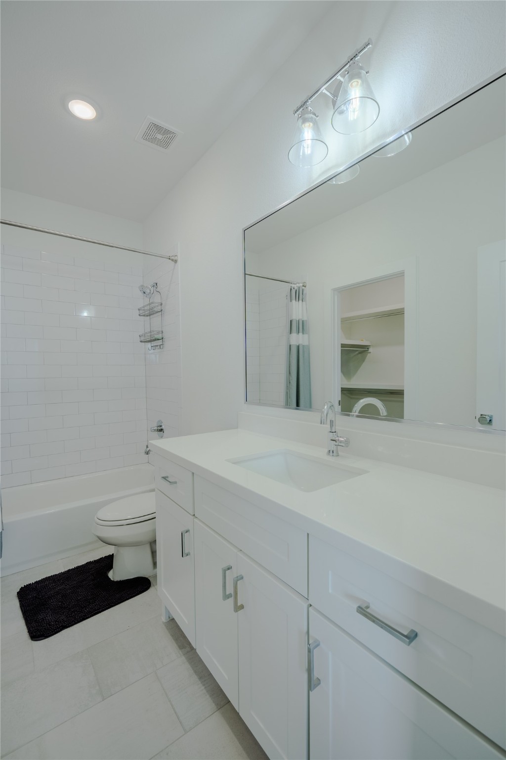 8810 Carousel Lane Houston, TX 77080 - Photo 28 of 37 a bathroom with a double vanity sink a toilet and a bathtub