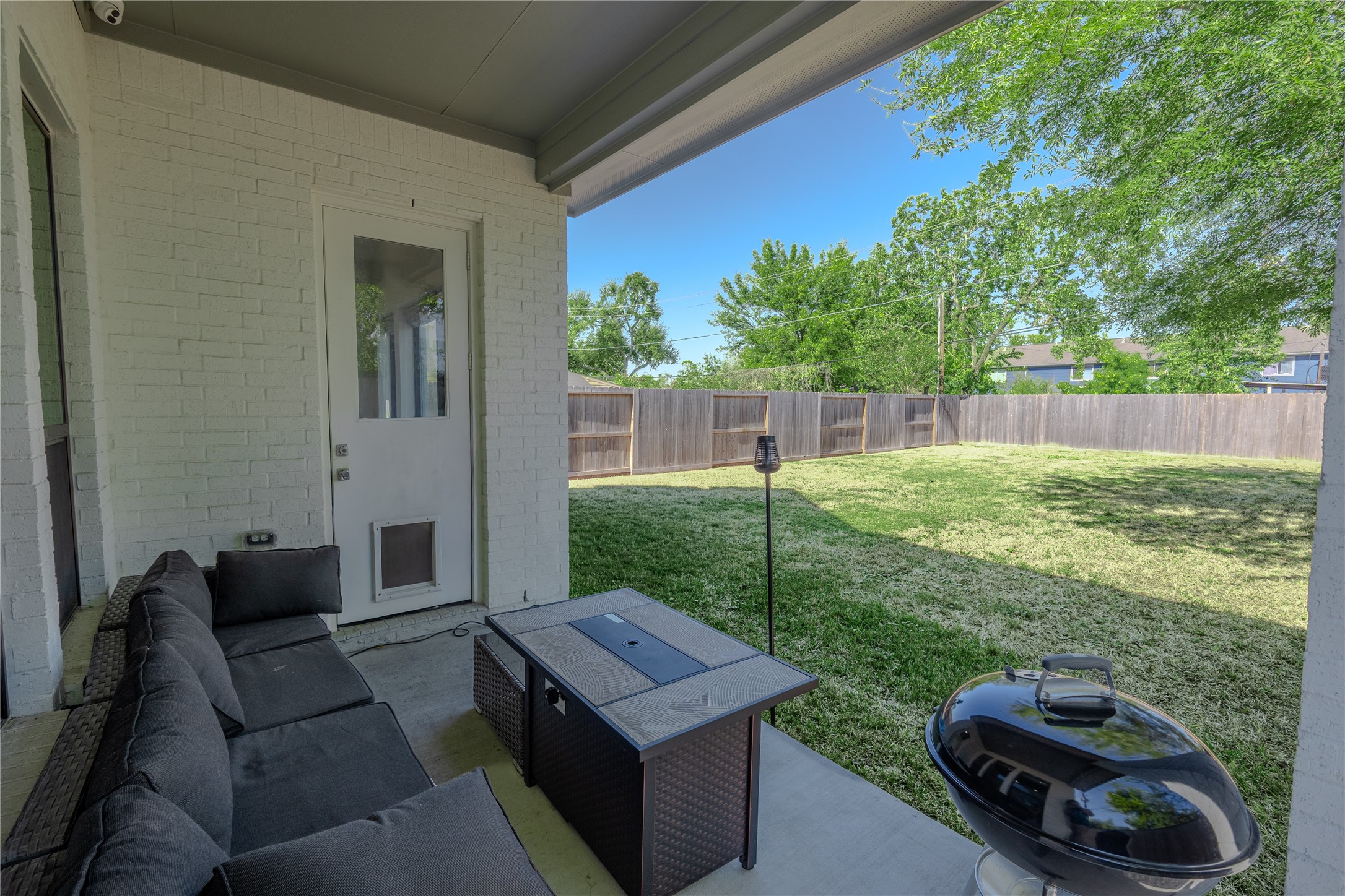 8810 Carousel Lane Houston, TX 77080 - Photo 36 of 37 a backyard of a house with table and chairs