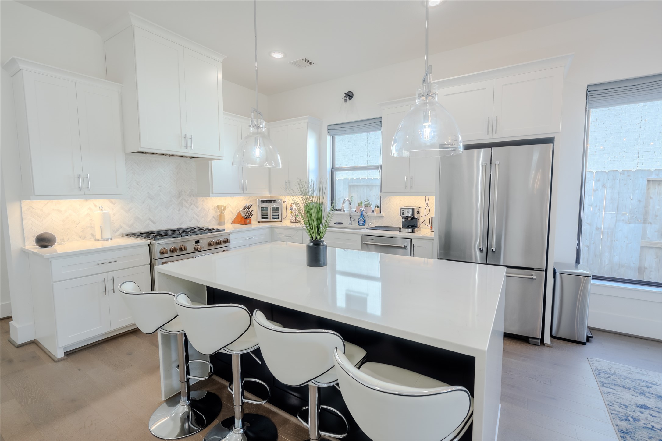8810 Carousel Lane Houston, TX 77080 - Photo 8 of 37 a kitchen with a dining table chairs stainless steel appliances and cabinets