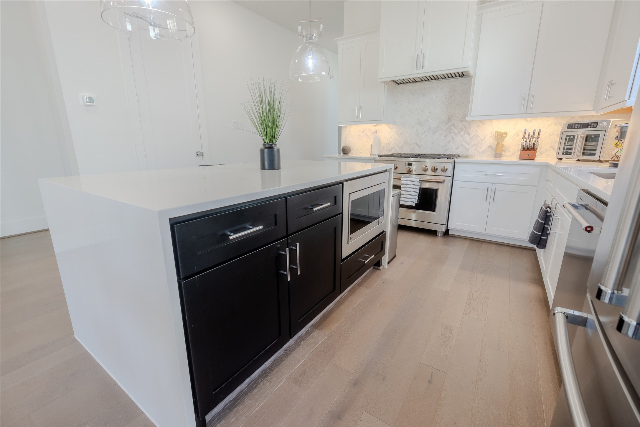 8810 Carousel Lane Houston, TX 77080 - Photo 9 of 37 a kitchen with stainless steel appliances a sink stove and refrigerator