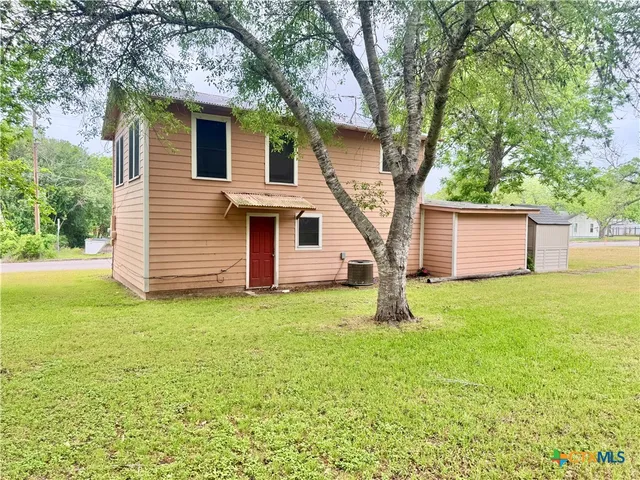 a house with a tree in front of it