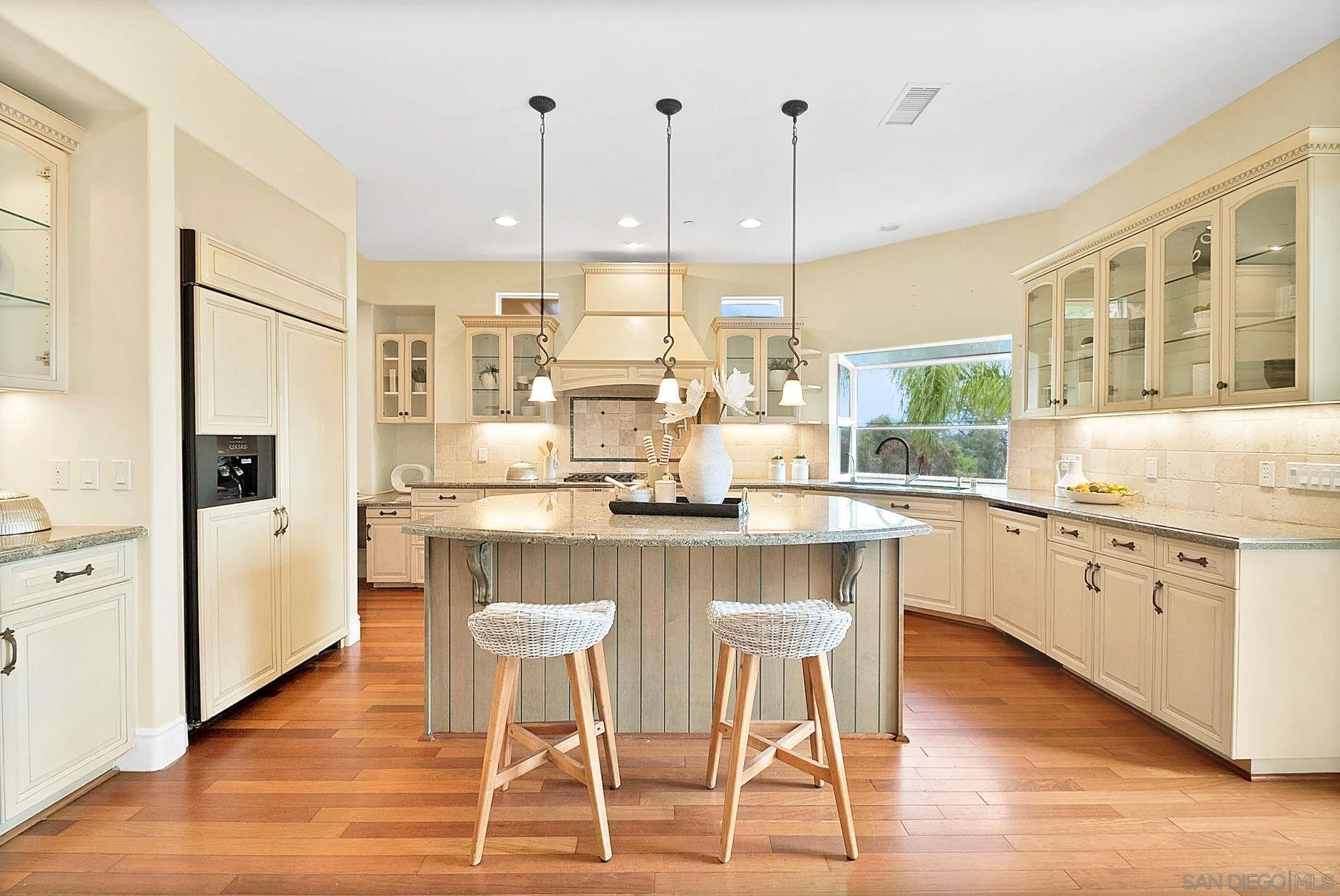 12920 Glen Circle Road Poway, CA 92064 - Photo 29 of 69 a kitchen with stainless steel appliances granite countertop a table chairs stove and wooden floor