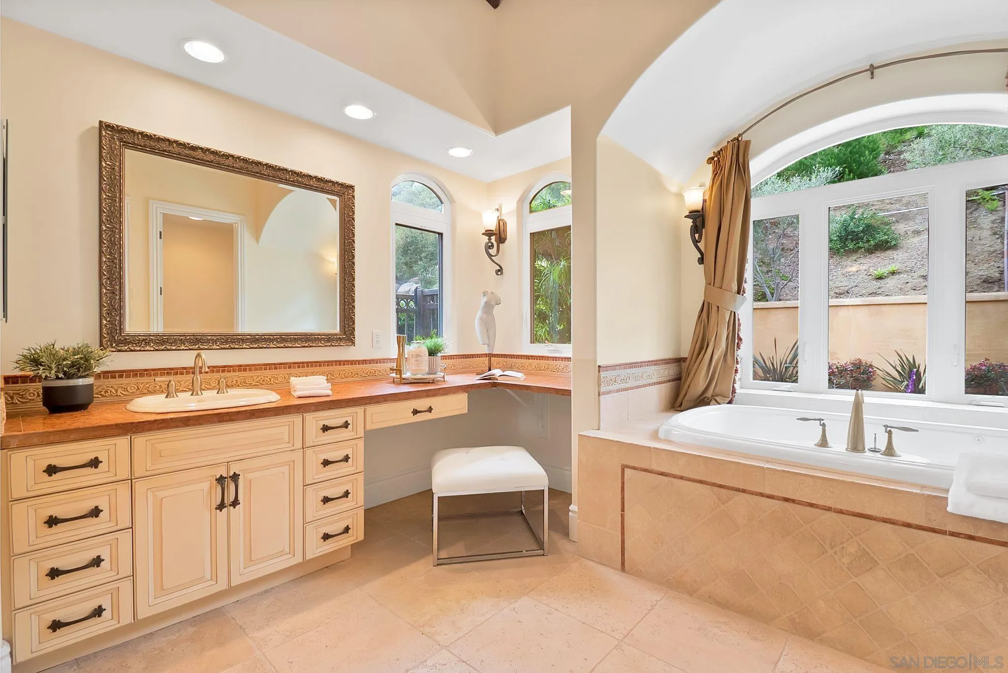12920 Glen Circle Road Poway, CA 92064 - Photo 37 of 69 a bathroom with a double vanity sink a mirror and a bathtub