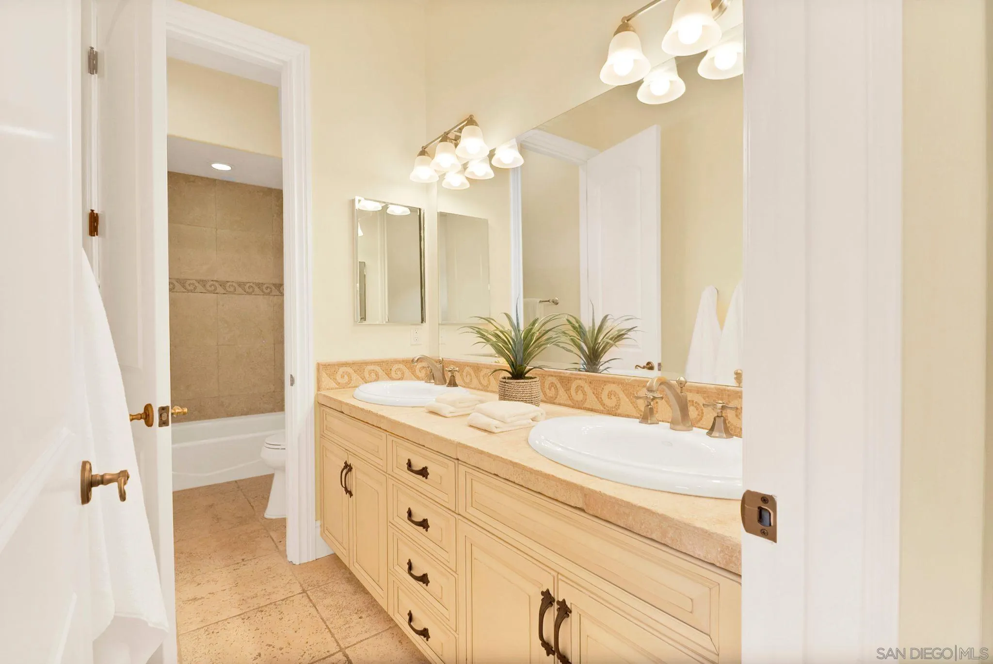 12920 Glen Circle Road Poway, CA 92064 - Photo 50 of 69 a bathroom with a granite countertop sink a mirror and a shower