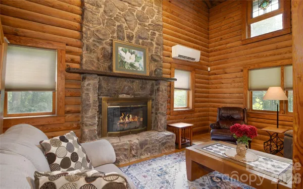 a living room with furniture a fireplace and a window