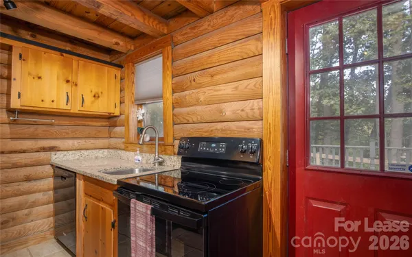 a kitchen that has a stove and a microwave oven