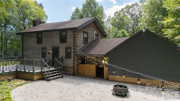 a backyard of a house with barbeque oven