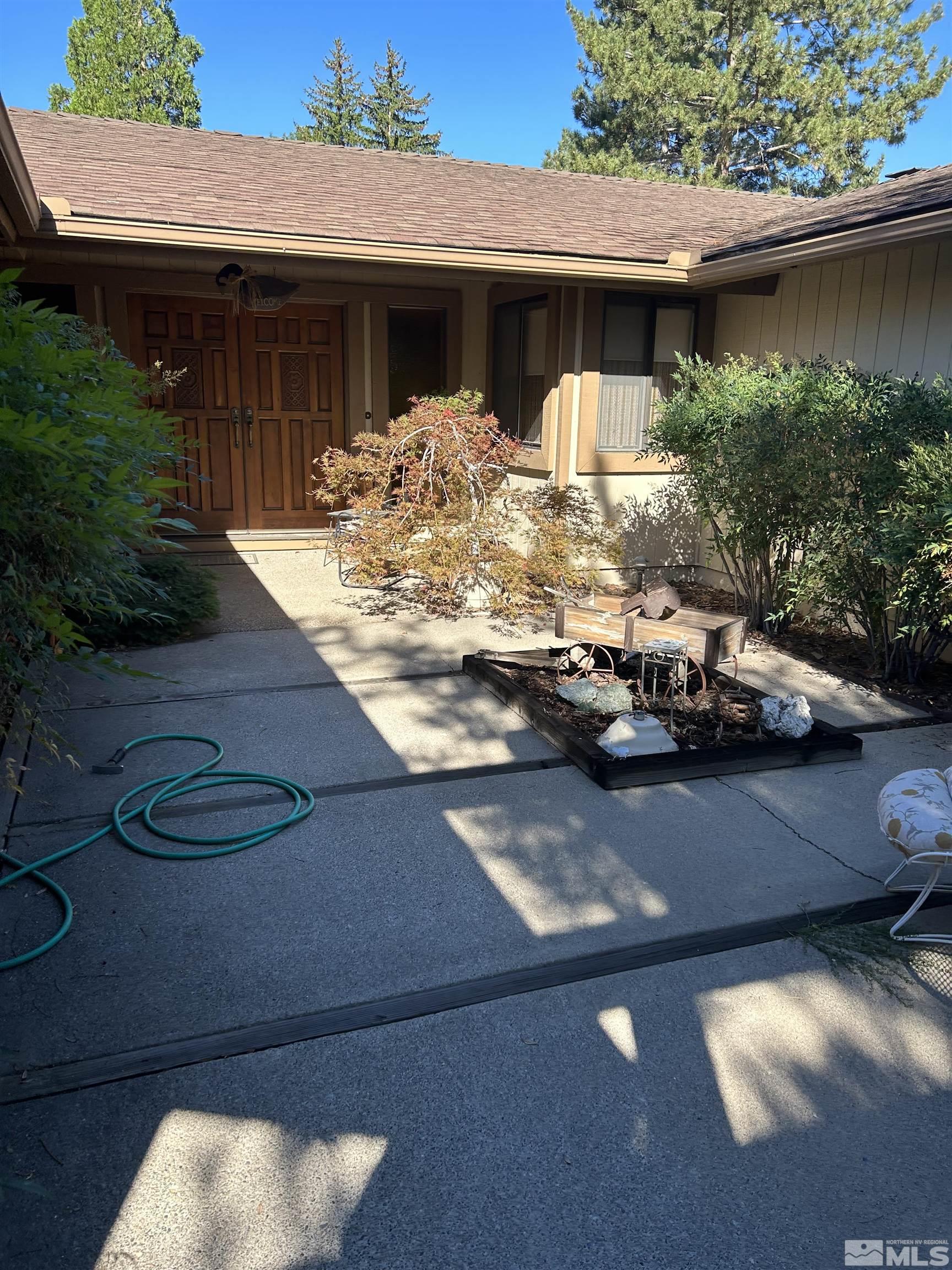 1475 Joshua Drive Reno, NV 89509 - Photo 1 of 27 a table and chairs sitting in front of a house