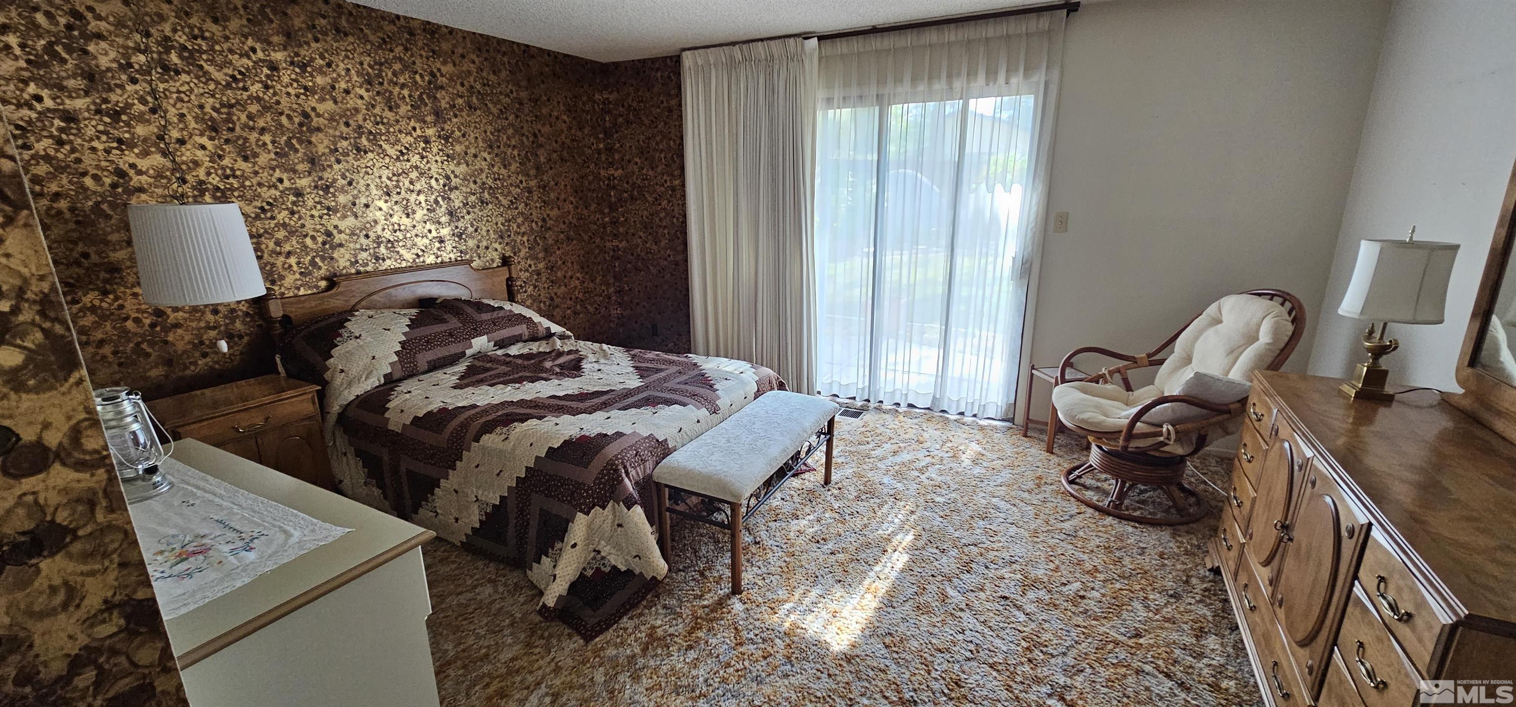 1475 Joshua Drive Reno, NV 89509 - Photo 12 of 27 a bed sitting in a bedroom next to a window