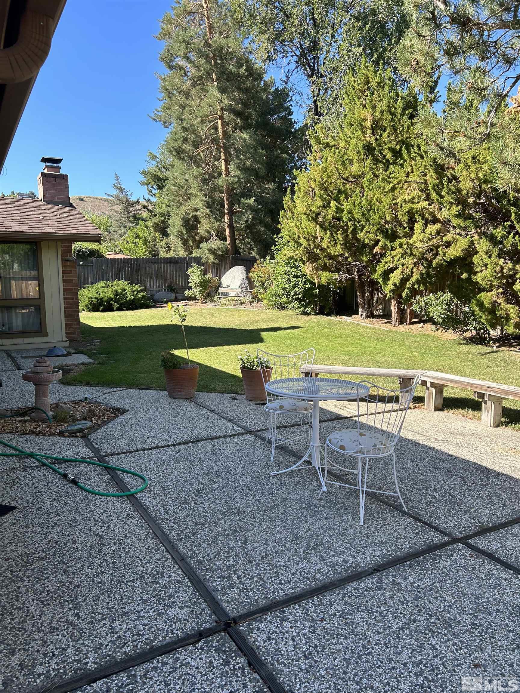 1475 Joshua Drive Reno, NV 89509 - Photo 22 of 27 a view of a swimming pool with a yard and sitting area