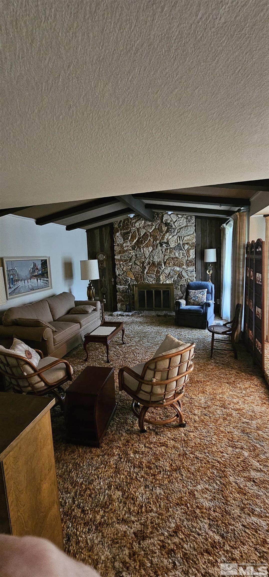 1475 Joshua Drive Reno, NV 89509 - Photo 8 of 27 a living room with furniture a rug and a floor to ceiling window