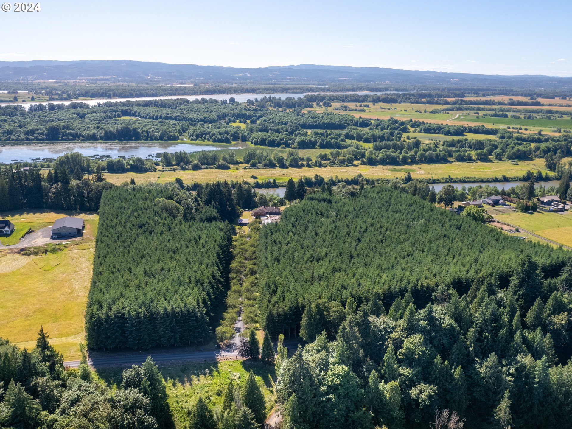 21920 Northwest 67th Avenue Ridgefield, WA 98642 - Photo 3 of 48 an aerial view of a residential houses with outdoor space and lake view