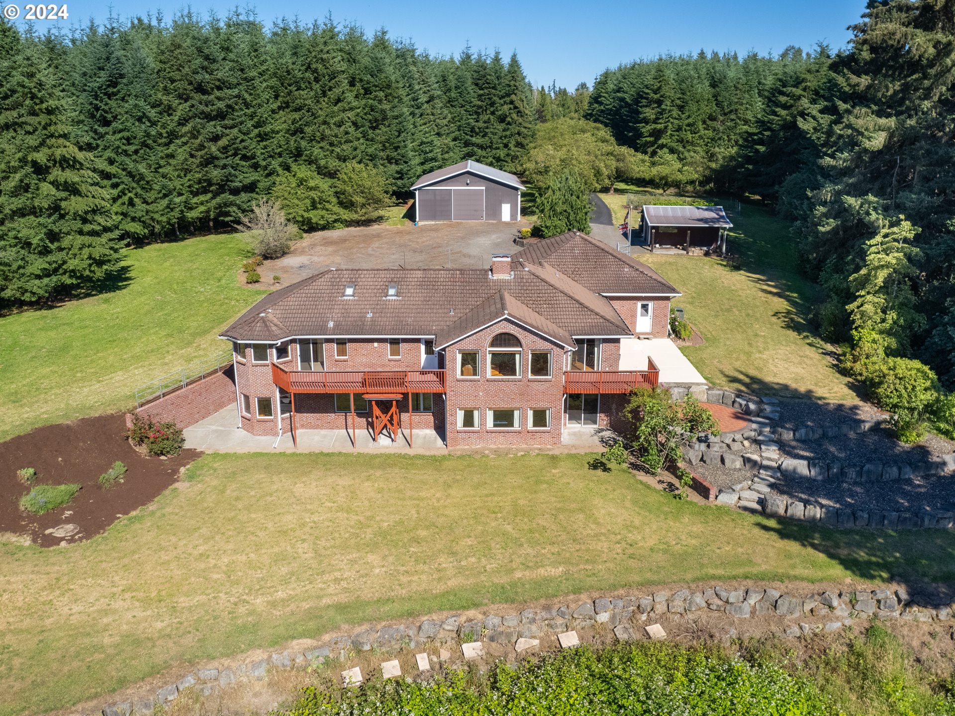 21920 Northwest 67th Avenue Ridgefield, WA 98642 - Photo 38 of 48 an aerial view of a house with swimming pool and garden