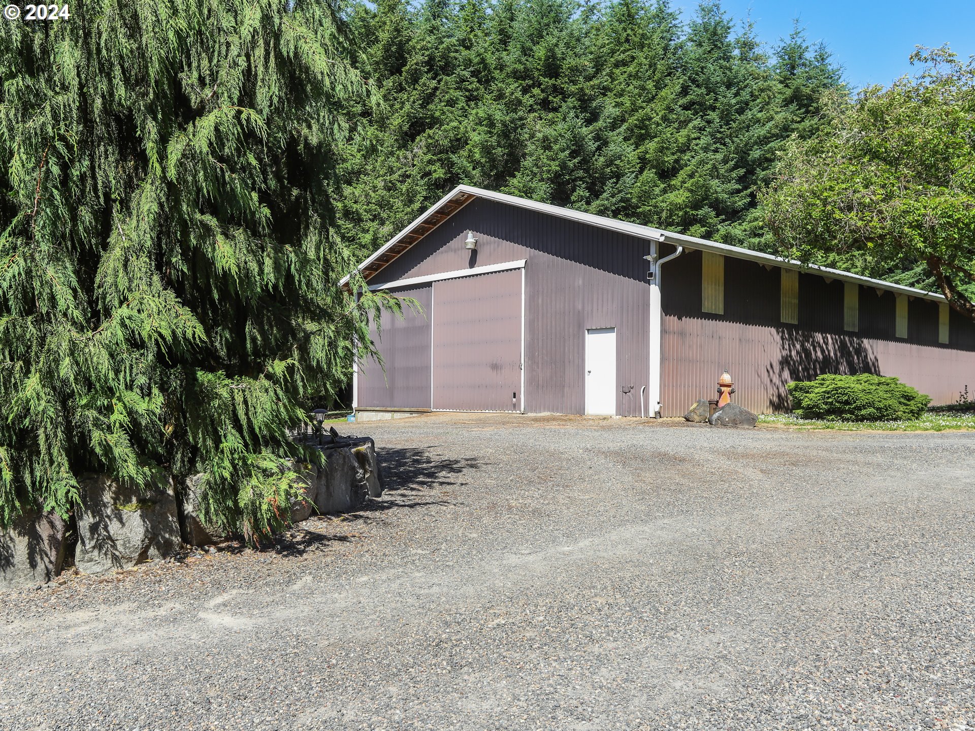 21920 Northwest 67th Avenue Ridgefield, WA 98642 - Photo 41 of 48 a view of a house with a yard and large trees