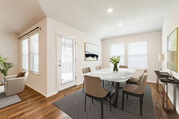 a living room with furniture a flat screen tv and a large window