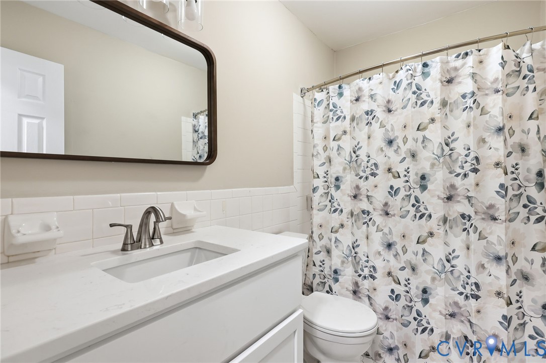 5106 Conduit Road Colonial Heights, VA 23834 - Photo 16 of 26 Bathroom with vanity, tile walls, and curtained sh