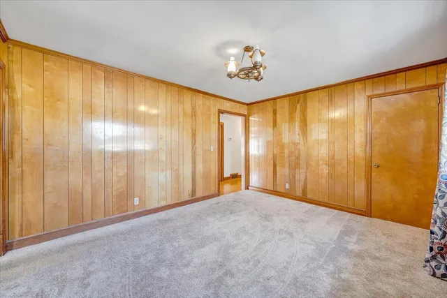 a view of a big room with wooden floor and windows in a room