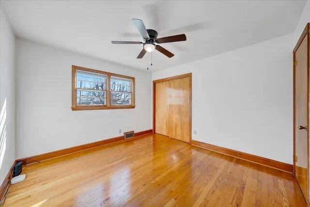 a bathroom with a granite countertop toilet sink and mirror