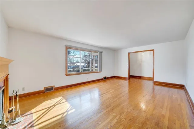 a view of a room with wooden floor and window
