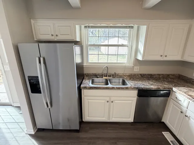 a kitchen with a stove and a white cabinet