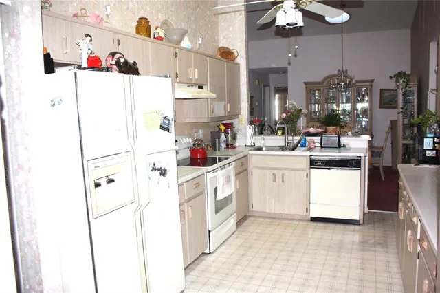 a kitchen with a white cabinets and white appliances